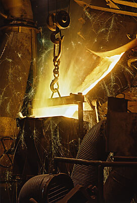 Molten iron pouring into holding vessel in Swedish foundry.