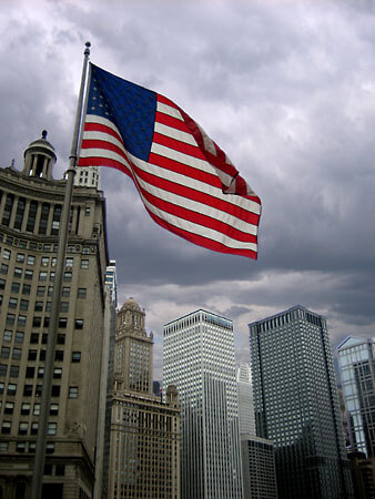 A US flag waving on a windy Chicago day. Looking over the Chicago River towards East Wacker Drive.