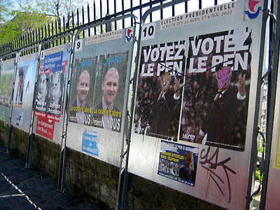 A row of political posters de-faced before the French election. Paris.