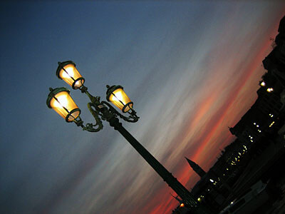 A streetlamp in Venice, Italy, at dusk. The glow is from the pink glass in the lamp.