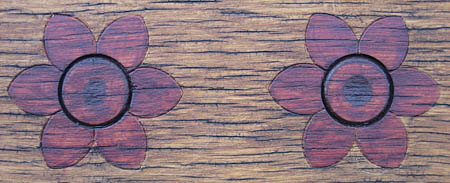 Pretty flower detail on a park bench.
