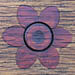 Pretty flower detail on a park bench.