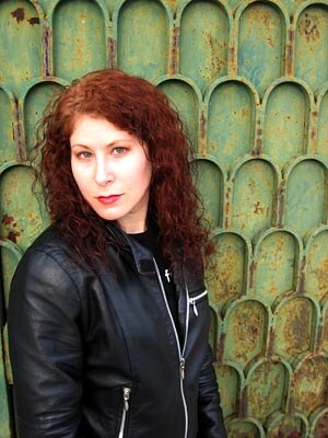 My wife Lauri in front of a green door.
