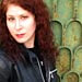 My wife Lauri in front of a green door.