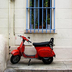 Walking around, I came across this old red scooter in a Marseille square.