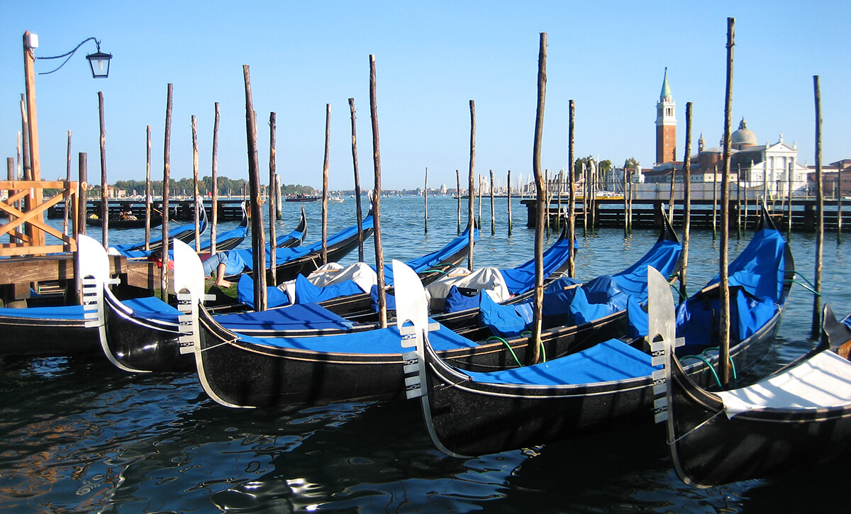 A row of gondolas on the Piazza San Marco pier in Venice, Italy.