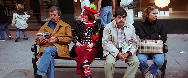 Street in Copenhagen with clown on a bench