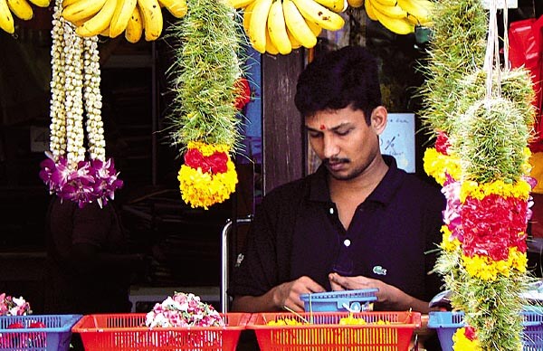 A flower weaver at Buffalo Road, Little India, Singapore