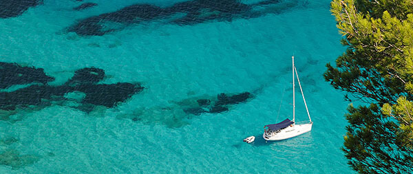 Water by Ibiza island with boat