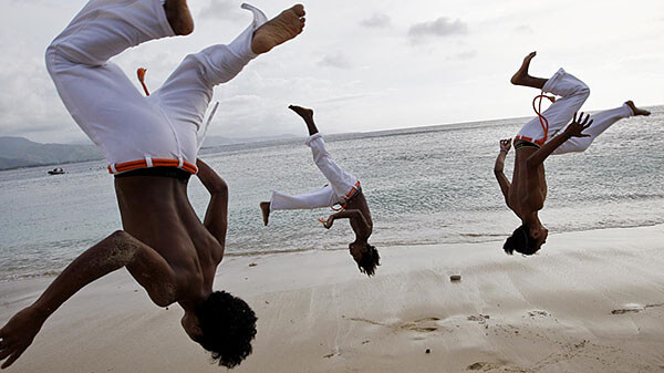 Practicing Capoeira moves on the beach