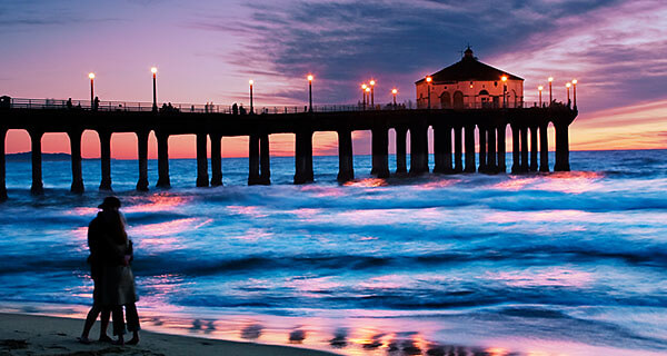 A couple at sunset by the pier