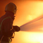 Fireman putting out a hotel fire