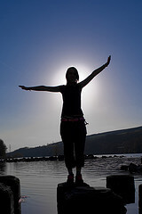 Silhouette of a girl against a blue sky