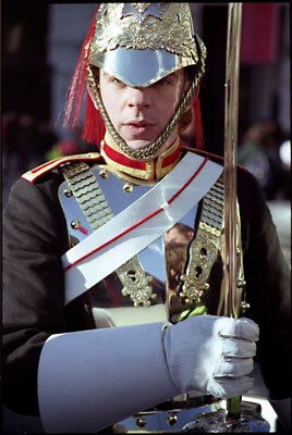 Soldier photographed during a recruitment drive in Trafalgar Square, London. His breast plate is so polished you can clearly see onlookers' reflections in it.