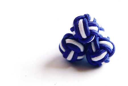 A pair of textile cufflinks.