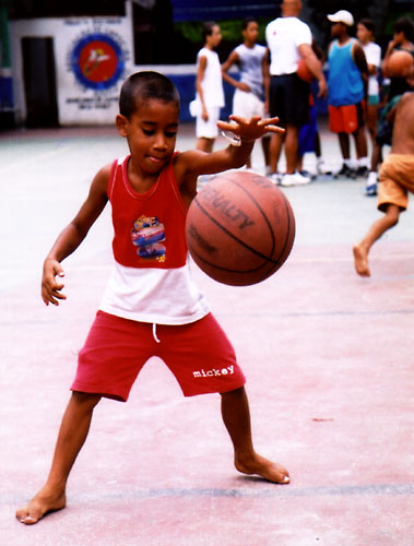 Boy playing basketball, Rocinha, Rio de Janeiro, Brazil.