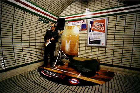 Busker in Leicester Square tube station.