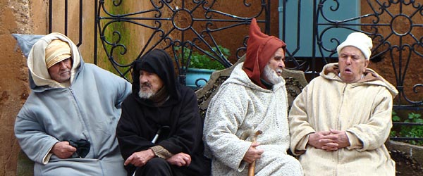 Men on a bench in Chefchaouen, Morocco